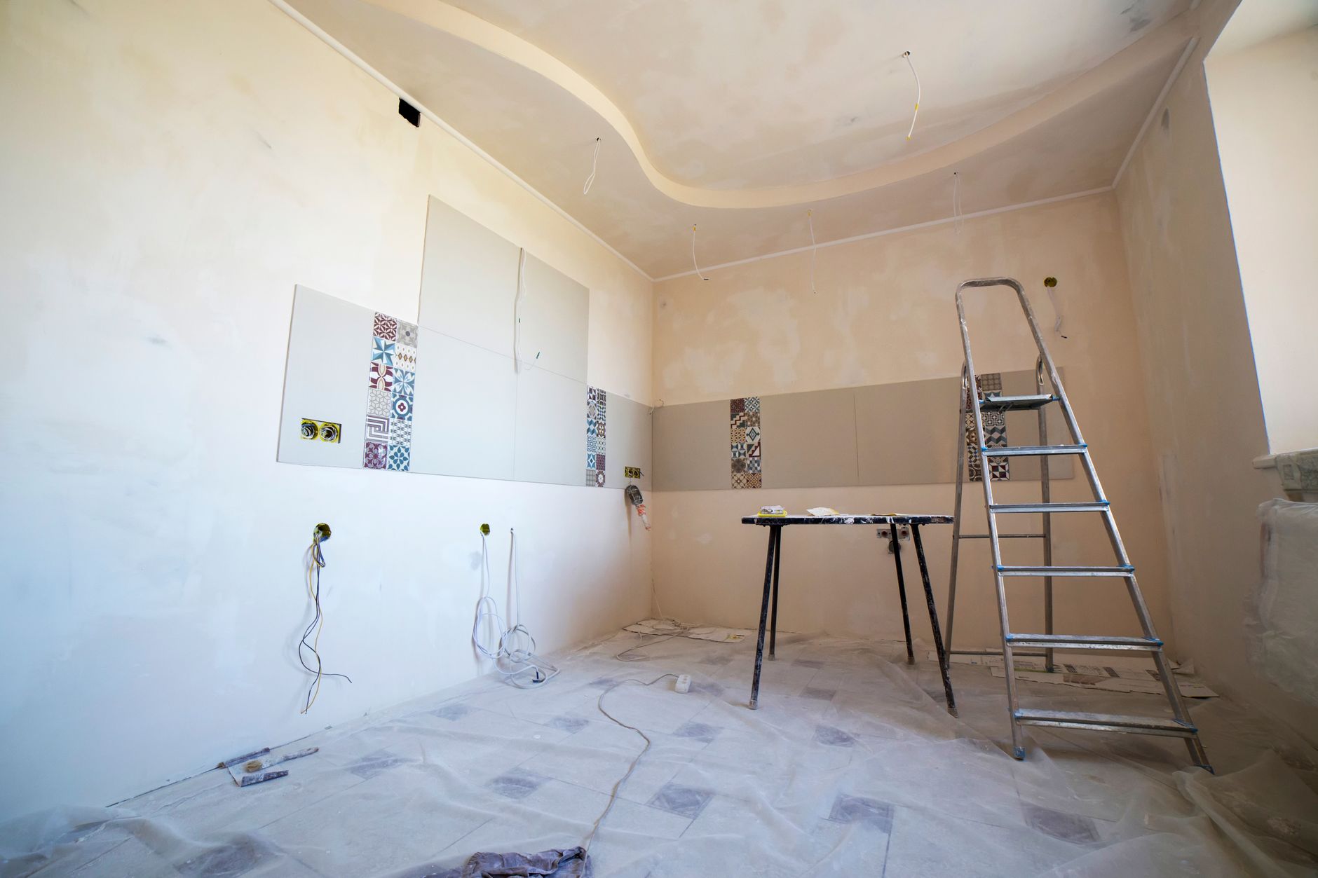 Contractor reviewing renovation plans inside a house being remodeled
